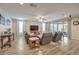 Spacious living area with tile floors, neutral tones, and sliding doors opening to an outdoor patio at 8257 Skye Peak St, Las Vegas, NV 89166