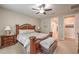 Serene main bedroom includes soft carpet, a ceiling fan, and coordinated wood furniture at 8257 Skye Peak St, Las Vegas, NV 89166