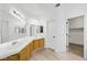 Bathroom with dual sinks, wood cabinets, and a walk-in closet at 8355 Cabin Peak St, Las Vegas, NV 89123