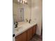 Bathroom featuring double sinks, a full-width mirror, and wood-look flooring at 8355 Cabin Peak St, Las Vegas, NV 89123