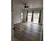 Bedroom with wood-look flooring and sliding glass door to the backyard at 8355 Cabin Peak St, Las Vegas, NV 89123