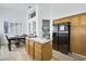 Eat-in kitchen showcasing wood cabinets, tiled counters, and stainless-steel appliances at 8355 Cabin Peak St, Las Vegas, NV 89123