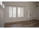 Bright living room featuring new wood floors, white walls, and updated window shutters at 8355 Cabin Peak St, Las Vegas, NV 89123
