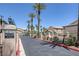 Community entrance with a guard gate and mature landscaping at 8410 Eldora Ave # 1045, Las Vegas, NV 89117