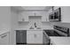 Updated kitchen features stainless appliances, white cabinets, and stone countertops at 8410 Eldora Ave # 1045, Las Vegas, NV 89117