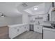 Updated kitchen with white cabinets, stainless appliances, and a breakfast bar at 8410 Eldora Ave # 1045, Las Vegas, NV 89117