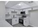 Updated kitchen features modern, stainless appliances and white cabinets and countertops at 8410 Eldora Ave # 1045, Las Vegas, NV 89117