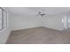 Living room features wood-look floors, ceiling fan, and view into the hallway at 8410 Eldora Ave # 1045, Las Vegas, NV 89117
