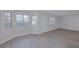 Bright and airy living room with wood-look floors, windows, and front door at 8410 Eldora Ave # 1045, Las Vegas, NV 89117