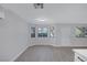 Bright and airy living room with wood-look floors, windows, and front door at 8410 Eldora Ave # 1045, Las Vegas, NV 89117