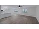 Open concept living and kitchen area with new flooring, light fixtures, and neutral walls at 8410 Eldora Ave # 1045, Las Vegas, NV 89117
