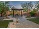 Inviting backyard featuring a covered patio with dining area and desert landscaping at 8647 Tortoise Canyon Ct, Las Vegas, NV 89148