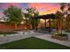 Inviting backyard featuring a covered patio with dining area and desert landscaping at 8647 Tortoise Canyon Ct, Las Vegas, NV 89148