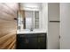 Modern bathroom features dark cabinets, white countertop, and wood-look accent wall at 8647 Tortoise Canyon Ct, Las Vegas, NV 89148