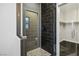 Modern bathroom with dark tiled shower, glass doors, and a separate toilet room at 8647 Tortoise Canyon Ct, Las Vegas, NV 89148