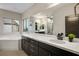 Modern bathroom with dual vanities, white countertops, and a soaking tub at 8647 Tortoise Canyon Ct, Las Vegas, NV 89148