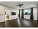 Light filled bedroom with dark wood floors, fan, and bathroom access at 8647 Tortoise Canyon Ct, Las Vegas, NV 89148