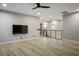 Bright bedroom area with wood flooring, ceiling fan, and access to the staircase at 8647 Tortoise Canyon Ct, Las Vegas, NV 89148