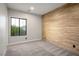 Inviting bedroom with wood accent wall and plush carpet offers a warm atmosphere at 8647 Tortoise Canyon Ct, Las Vegas, NV 89148