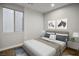 This bedroom features a neutral color palette, and modern artwork, creating a calming and stylish space at 8647 Tortoise Canyon Ct, Las Vegas, NV 89148