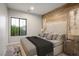 A serene bedroom boasts natural wood accent wall, creating a warm and inviting atmosphere at 8647 Tortoise Canyon Ct, Las Vegas, NV 89148