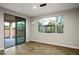 Bright dining area with outdoor views from a large window and sliding door at 8647 Tortoise Canyon Ct, Las Vegas, NV 89148