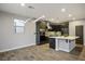 Dining area with dark cabinets, stainless appliances, and modern lighting fixture at 8647 Tortoise Canyon Ct, Las Vegas, NV 89148