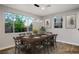 Bright dining room with large windows, modern lighting, and a spacious table for gatherings at 8647 Tortoise Canyon Ct, Las Vegas, NV 89148