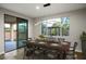 Dining area with modern light fixture, table set, and a view of outdoor space at 8647 Tortoise Canyon Ct, Las Vegas, NV 89148