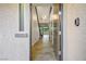 A stunning entryway with wood-look flooring, a modern light fixture, and a view of the staircase at 8647 Tortoise Canyon Ct, Las Vegas, NV 89148