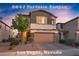 Charming two-story home with a two car garage, stone accents, and landscaped front yard at 8647 Tortoise Canyon Ct, Las Vegas, NV 89148