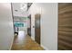 A stylish hallway showcases wood-look tile flooring, modern lighting, and a glimpse into the living area at 8647 Tortoise Canyon Ct, Las Vegas, NV 89148
