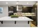 Kitchen with an island, dark cabinets, stainless appliances, and under cabinet lighting at 8647 Tortoise Canyon Ct, Las Vegas, NV 89148