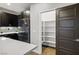 Kitchen area with stainless steel refrigerator, pantry and decorative backsplash at 8647 Tortoise Canyon Ct, Las Vegas, NV 89148