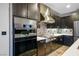 Modern kitchen with dark cabinets, stainless steel appliances, and decorative backsplash at 8647 Tortoise Canyon Ct, Las Vegas, NV 89148