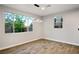 Bright living room boasts wood floors, modern light fixture and large windows showcasing outdoor view at 8647 Tortoise Canyon Ct, Las Vegas, NV 89148