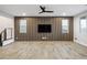 Spacious living room with a wood slat feature wall and hard surface floors at 8647 Tortoise Canyon Ct, Las Vegas, NV 89148