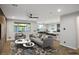 Bright, open-concept living room with a ceiling fan and large windows overlooking the backyard at 8647 Tortoise Canyon Ct, Las Vegas, NV 89148