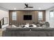 Modern living room featuring a sleek accent wall, stylish furnishings and a ceiling fan at 8647 Tortoise Canyon Ct, Las Vegas, NV 89148