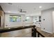 Open living space featuring wood-look flooring, ample natural light, and a view of the kitchen and outdoor space at 8647 Tortoise Canyon Ct, Las Vegas, NV 89148