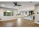 Open living space featuring wood-look flooring, ample natural light, and a view of the kitchen at 8647 Tortoise Canyon Ct, Las Vegas, NV 89148