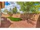 Spacious backyard with turf, rock landscaping, and brick walls at 8664 Frasure Falls Ave, Las Vegas, NV 89178