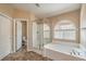 Bathroom featuring a glass shower, soaking tub, and tile flooring at 8664 Frasure Falls Ave, Las Vegas, NV 89178