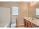 Bathroom featuring a sink with wooden cabinets, a large mirror and combined shower with tub at 8664 Frasure Falls Ave, Las Vegas, NV 89178