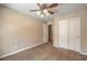 Bedroom with carpet, a ceiling fan, closet, and an open door leading to another room at 8664 Frasure Falls Ave, Las Vegas, NV 89178