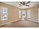 Bedroom featuring three windows allowing bright natural light and carpeted flooring at 8664 Frasure Falls Ave, Las Vegas, NV 89178