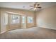 Spacious carpeted bedroom featuring a ceiling fan and bright natural light from multiple windows at 8664 Frasure Falls Ave, Las Vegas, NV 89178