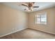 Neutral bedroom featuring carpet, ceiling fan, and a window providing natural light at 8664 Frasure Falls Ave, Las Vegas, NV 89178
