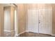 Interior entrance featuring beige walls, ceramic tile flooring, and white trim at 8664 Frasure Falls Ave, Las Vegas, NV 89178