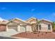 Inviting single-story home featuring a three-car garage, desert landscaping, and neutral stucco exterior at 8664 Frasure Falls Ave, Las Vegas, NV 89178